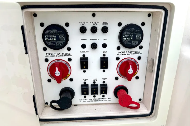 Slide: The Image of Control panel of a 2023 Sea Chaser 30 HFC CC boat, featuring battery switches and circuit breakers. - 33