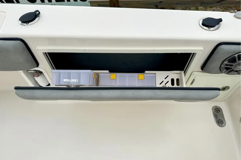 Slide: The Image of 2023 Sea Chaser 30 HFC CC boat storage compartment with organized tackle boxes. - 34