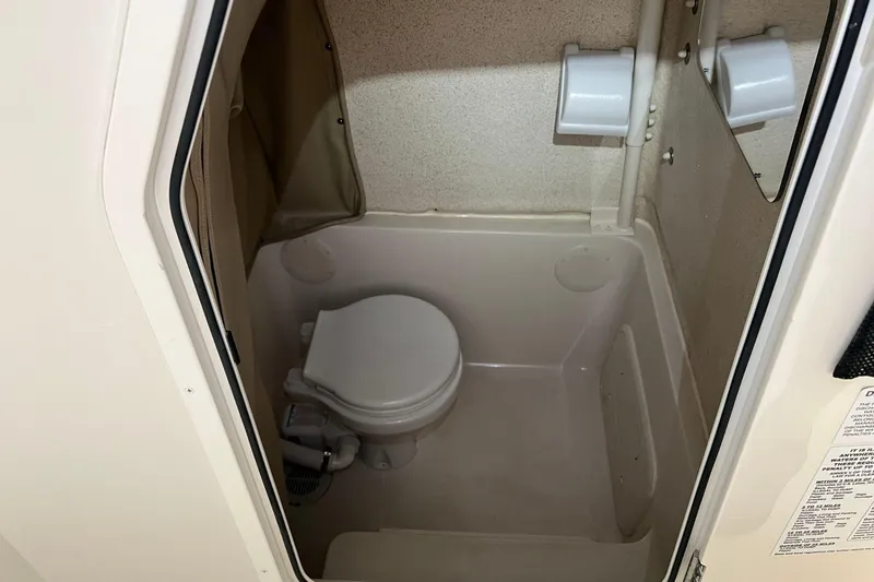 Slide: The Image of 2023 Sea Chaser 30 HFC CC boat interior bathroom with compact toilet. - 39