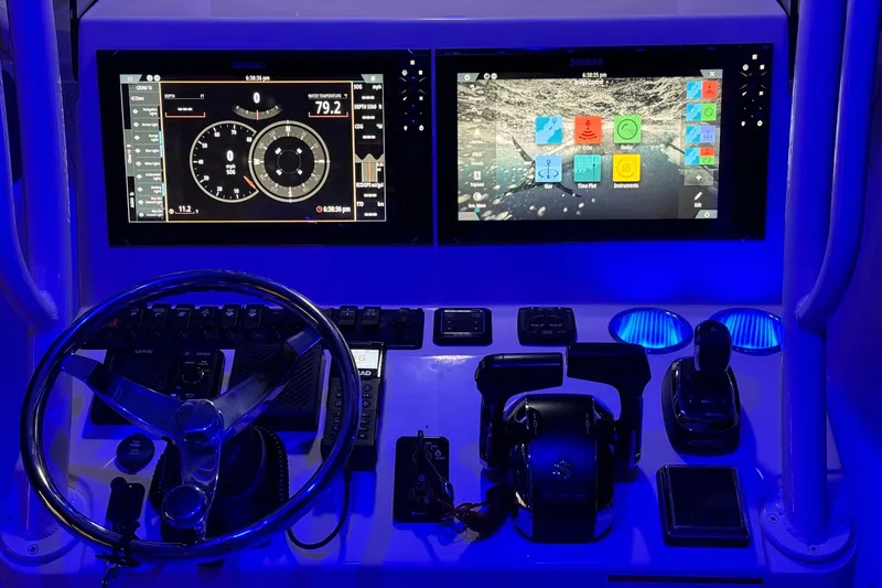 Slide: The Image of 2023 Sea Chaser 30 HFC CC boat dashboard with dual displays and illuminated controls. - 52