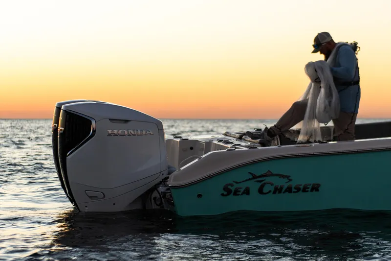 Slide: The Image of 2023 Sea Chaser 30 HFC CC boat with Honda engine at sunset on the water. - 53