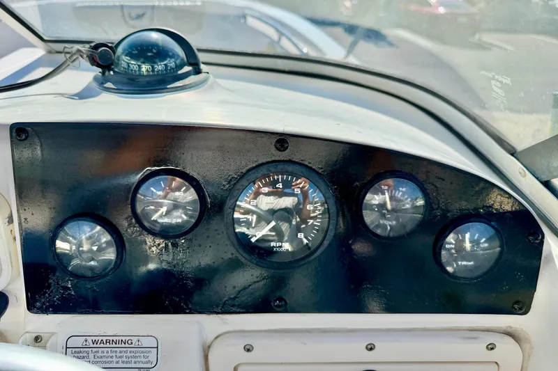 Slide: The Image of Dashboard of a 2009 Mako 216 Dual Console boat with gauges and compass. - 15