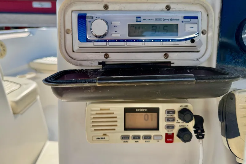 Slide: The Image of Boat dashboard with Dual radio and Uniden marine radio on a 2009 Mako 216 Dual Console. - 17