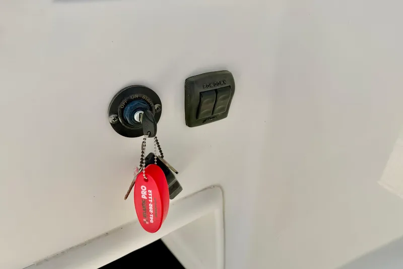 Slide: The Image of Key ignition and control panel on 2009 Mako 216 Dual Console boat. - 18