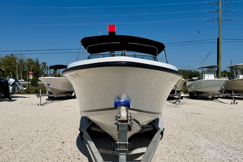 The Image of 2009 Mako 216 Dual Console boat on trailer in sunny outdoor setting. - 2