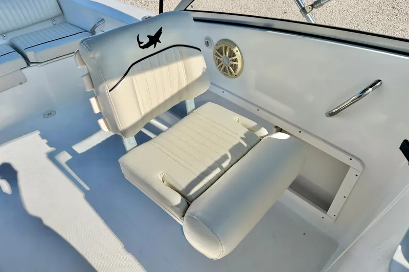 Slide: The Image of 2009 Mako 216 Dual Console boat interior with cushioned seating and speaker. - 20