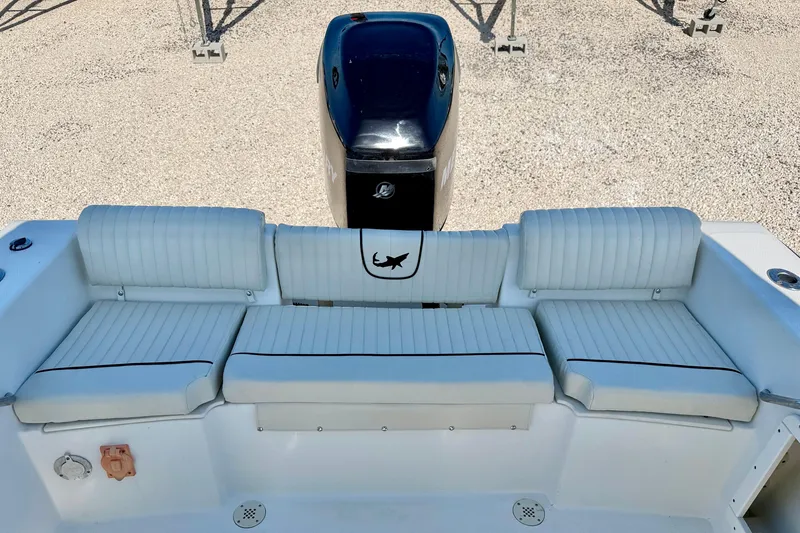 Slide: The Image of 2009 Mako 216 Dual Console boat with cushioned seating and outboard motor. - 22