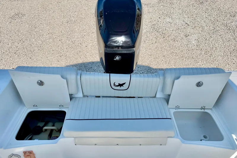 Slide: The Image of 2009 Mako 216 Dual Console boat with outboard motor and seating area. - 23