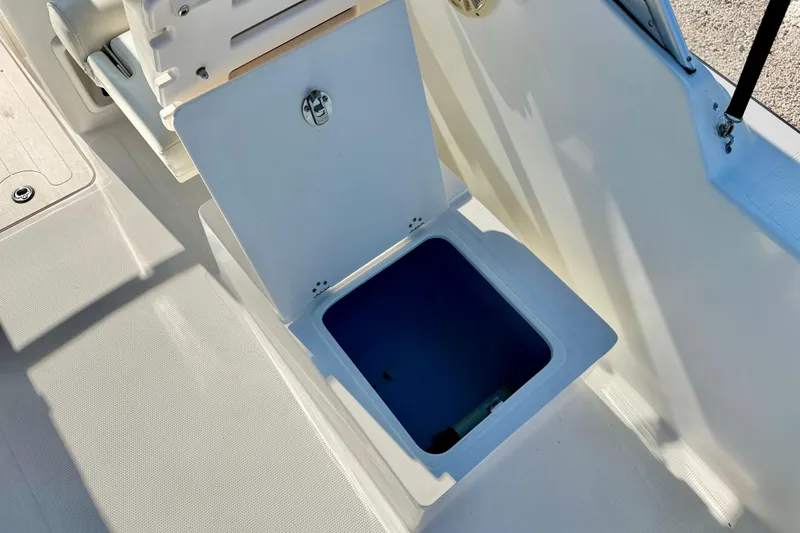 Slide: The Image of Open storage compartment on a 2009 Mako 216 Dual Console boat. - 26