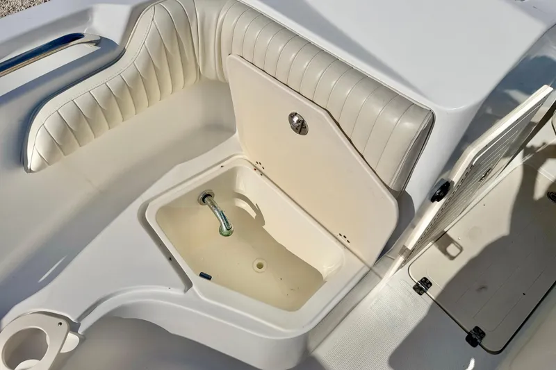 Slide: The Image of 2009 Mako 216 Dual Console boat interior with open storage compartments. - 27