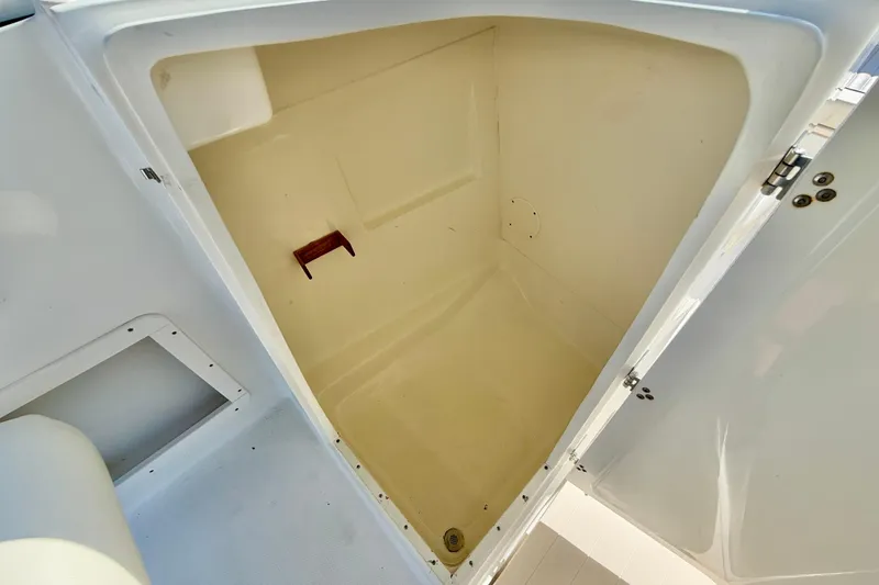 Slide: The Image of Storage compartment inside a 2009 Mako 216 Dual Console boat. - 28