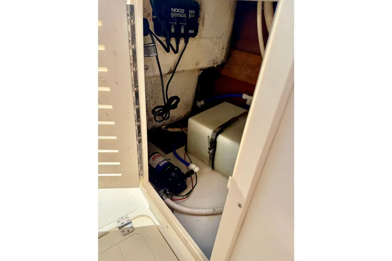 Slide: The Image of Interior view of a 2009 Mako 216 Dual Console boat compartment with equipment. - 29