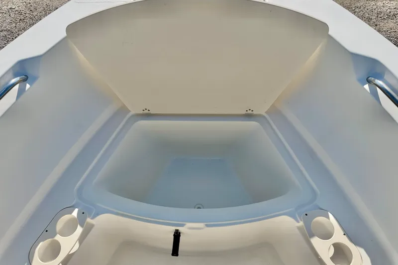Slide: The Image of 2009 Mako 216 Dual Console boat interior with storage and cup holders. - 31
