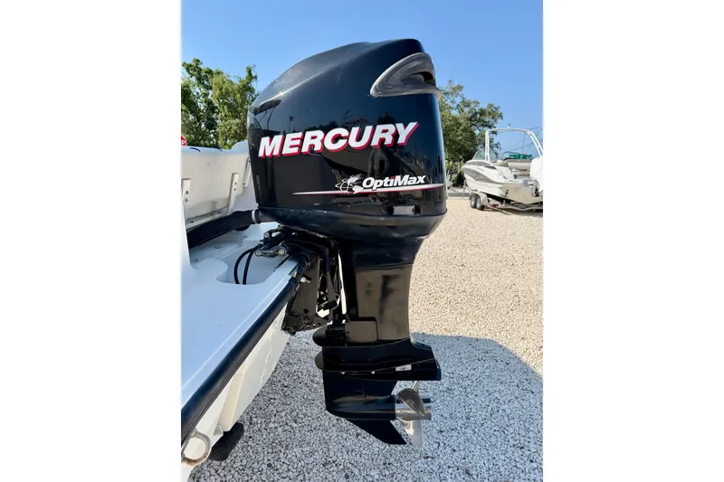 Slide: The Image of Mercury OptiMax outboard motor on 2009 Mako 216 Dual Console boat. - 34
