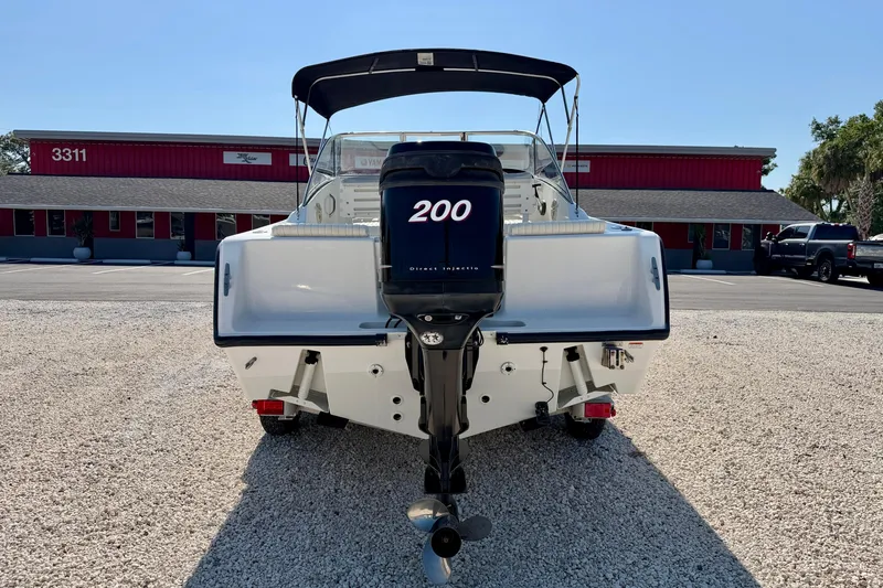 Slide: The Image of 2009 Mako 216 Dual Console boat with Yamaha 200 engine, parked on gravel. - 6
