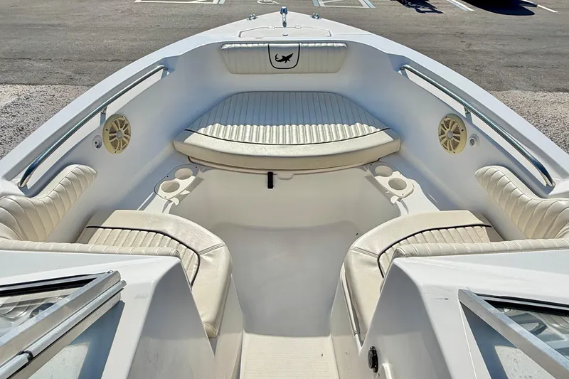 Slide: The Image of 2009 Mako 216 Dual Console boat interior with white seating and cup holders. - 9
