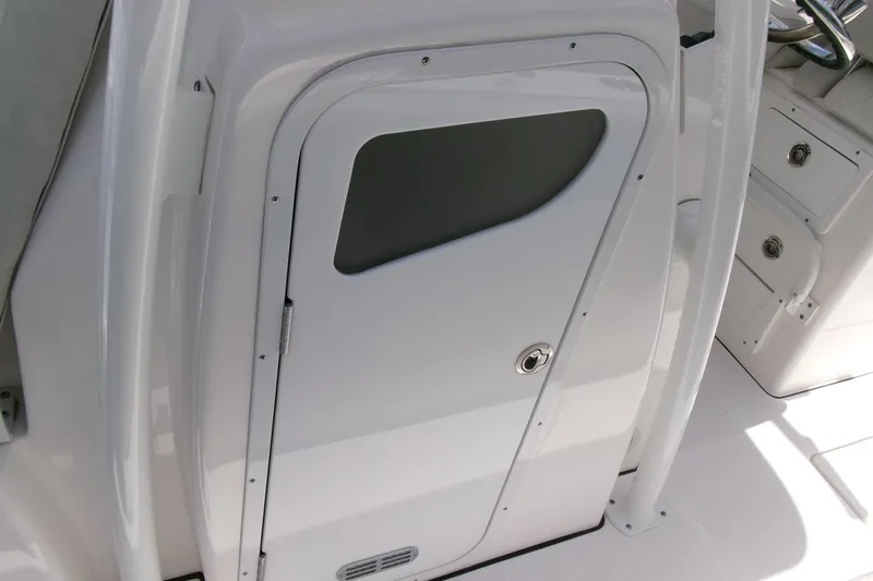 Slide: The Image of 2022 Sea Fox 288 Commander boat cabin door, sleek white design with secure lock. - 12