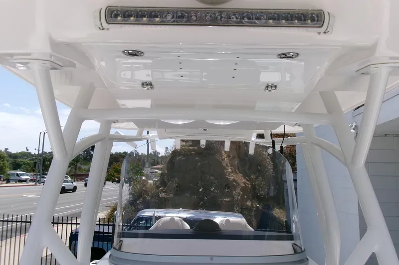 Slide: The Image of 2022 Sea Fox 288 Commander boat with T-top and windshield, parked outdoors. - 16