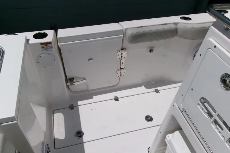 Slide: The Image of 2022 Sea Fox 288 Commander boat interior, featuring a clean, white deck and storage compartments. - 27