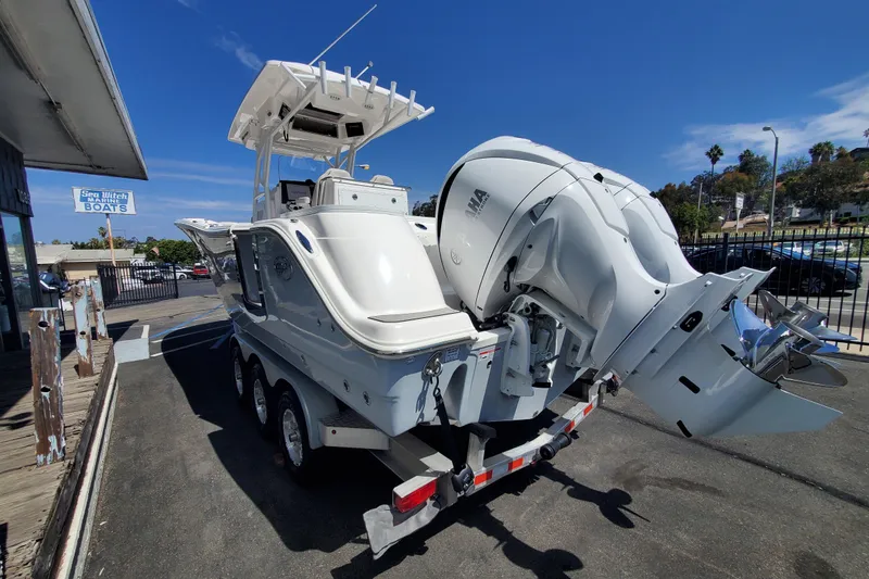 Slide: The Image of 2022 Sea Fox 288 Commander boat on trailer, displayed at a marine dealership under clear blue skies. - 3