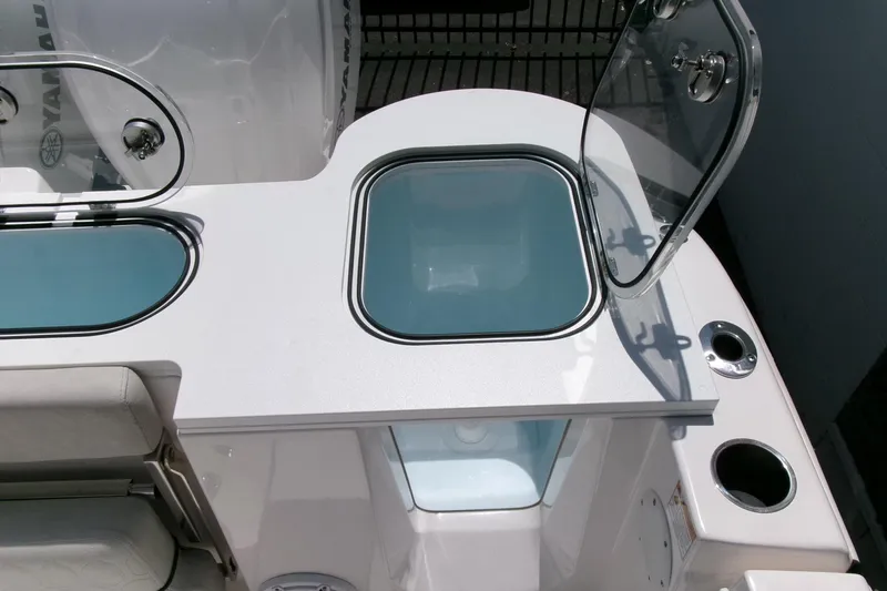 Slide: The Image of 2022 Sea Fox 288 Commander boat with open storage compartments and cup holders. - 37