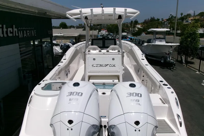 Slide: The Image of 2022 Sea Fox 288 Commander boat with dual 300 V6 engines, docked at a marina. - 41