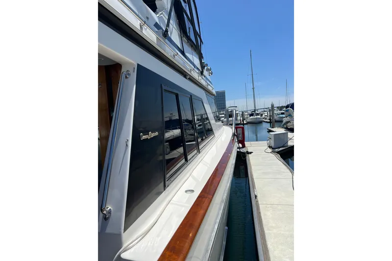 Slide: The Image of Cockpit of 1990 Ocean Alexander 42 yacht with helm and seating, docked at marina. - 11