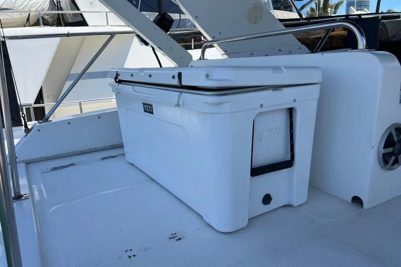 Slide: The Image of Interior seating of a 1990 Ocean Alexander 42 yacht, featuring white upholstery and sleek design. - 13
