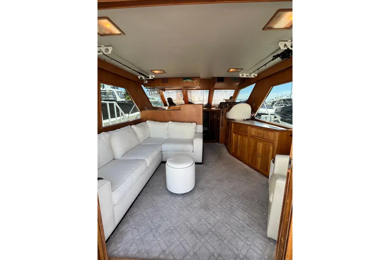 Slide: The Image of Deck seating area on a 1990 Ocean Alexander 42 yacht with striped cushions. - 14