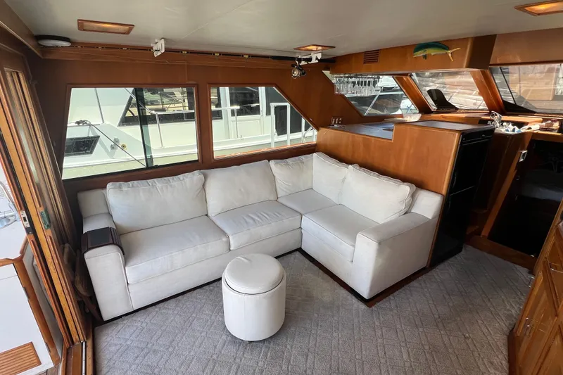Slide: The Image of Interior of 1990 Ocean Alexander 42 yacht with wooden cabinetry and modern TV setup. - 19