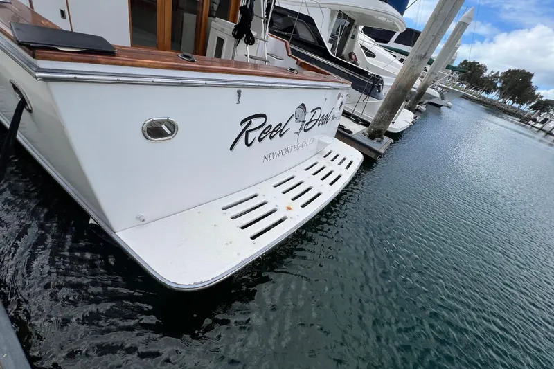 Slide: The Image of Ocean Alexander 42 yacht, 1990 model, docked at marina under clear blue sky. - 2