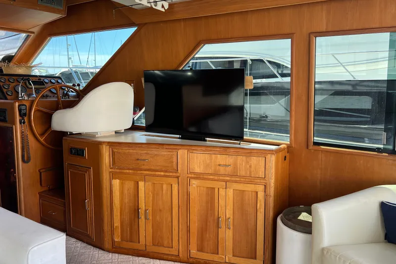 Slide: The Image of White leather seat on 1990 Ocean Alexander 42 yacht, wooden interior, window view. - 22