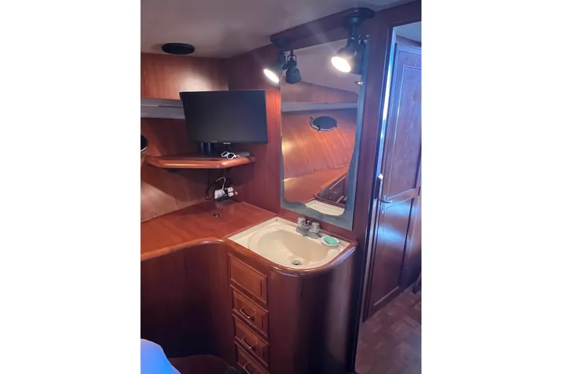Slide: The Image of Cozy cabin interior of 1990 Ocean Alexander 42 yacht with twin beds and wooden cabinetry. - 35
