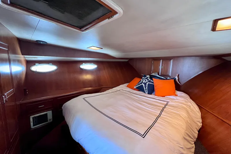 Slide: The Image of Cozy cabin interior of 1990 Ocean Alexander 42 yacht with plush pillows and warm lighting. - 41