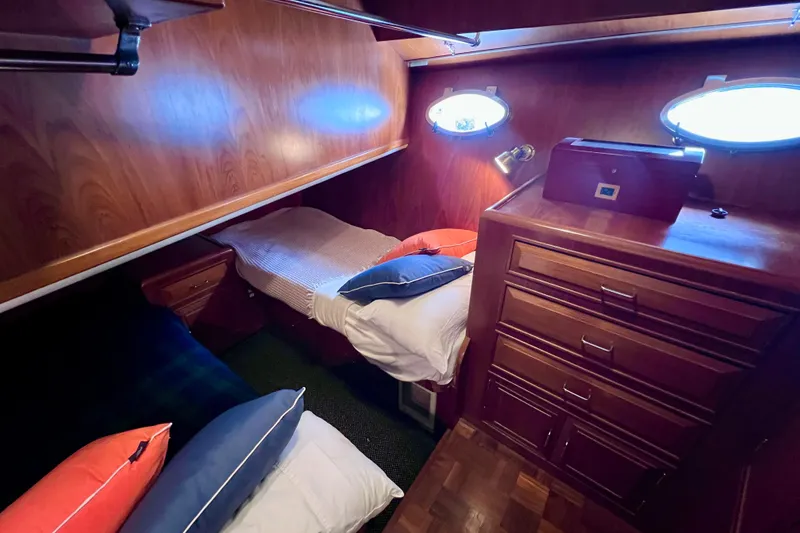 Slide: The Image of Cozy cabin interior of 1990 Ocean Alexander 42 yacht with wooden furnishings and porthole windows. - 43