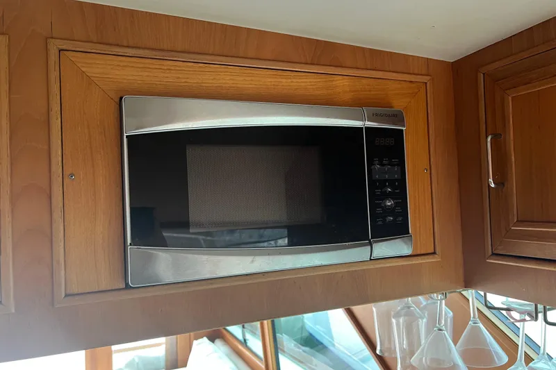 Slide: The Image of Electrical control panel of a 1990 Ocean Alexander 42 yacht, featuring gauges and switches. - 44