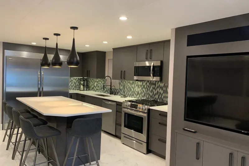 Slide: The Image of Modern kitchen with island, pendant lights, stainless steel appliances, and geometric backsplash, 2019 Adonia Utopia. - 19