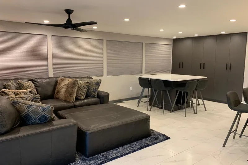 Slide: The Image of Modern living area with leather sofa, stylish cushions, and sleek dining table, Adonia Utopia Trip 2019. - 4