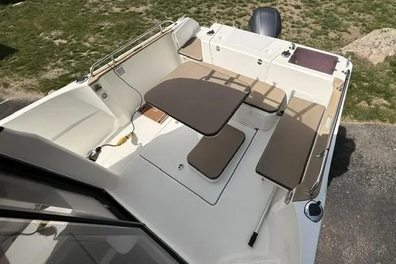 Slide: The Image of 2018 Jeanneau NC Sport 695 boat interior with seating and table setup. - 10