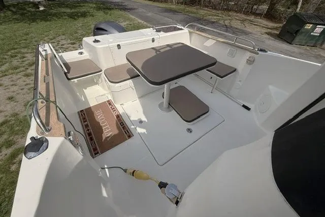 Slide: The Image of 2018 Jeanneau NC Sport 695 boat deck with seating and table setup. - 11
