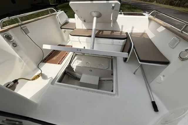 Slide: The Image of 2018 Jeanneau NC Sport 695 boat interior with seating and storage compartments. - 12