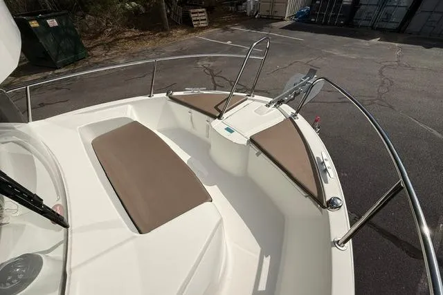 Slide: The Image of 2018 Jeanneau NC Sport 695 boat deck with cushioned seating and stainless steel railings. - 14