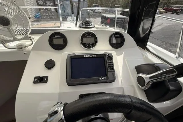 Slide: The Image of Helm of 2018 Jeanneau NC Sport 695 with Lowrance navigation system and Yamaha gauges. - 18