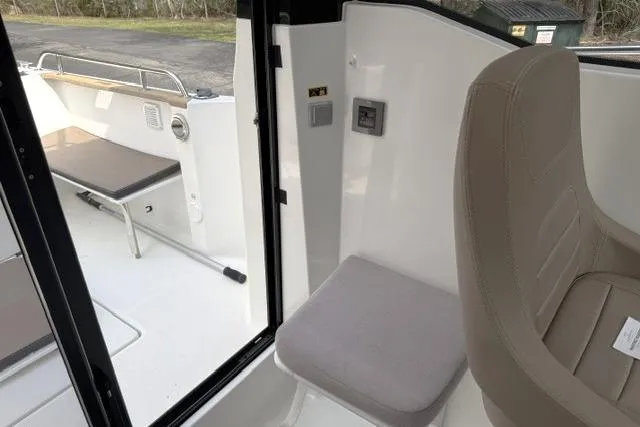 Slide: The Image of 2018 Jeanneau NC Sport 695 interior with seating and deck view. - 19