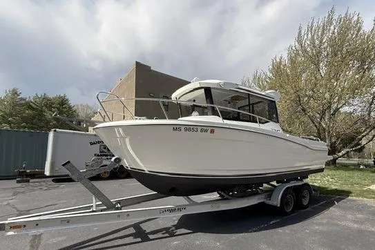 Slide: The Image of 2018 Jeanneau NC Sport 695 boat on trailer, parked outdoors. - 2