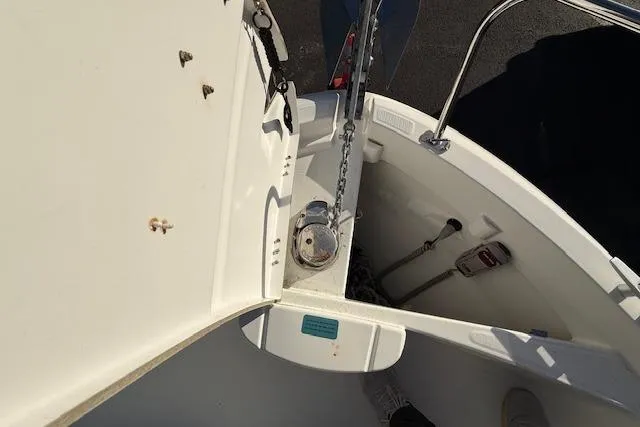 Slide: The Image of Anchor compartment of 2018 Jeanneau NC Sport 695 boat, featuring chain and winch. - 26