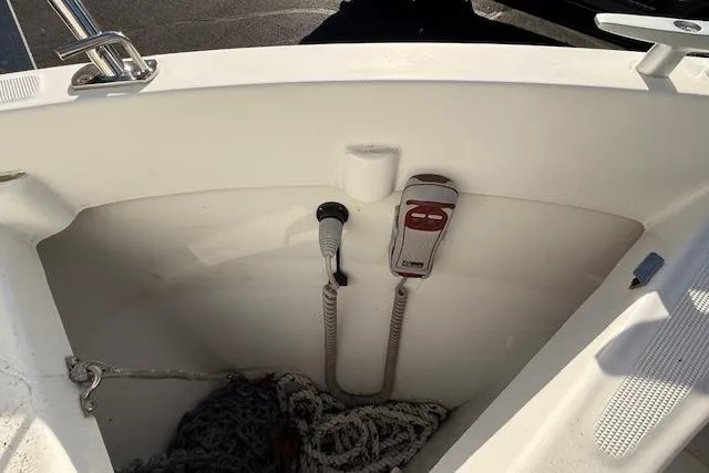 Slide: The Image of 2018 Jeanneau NC Sport 695 boat interior with rope storage and control panel. - 27