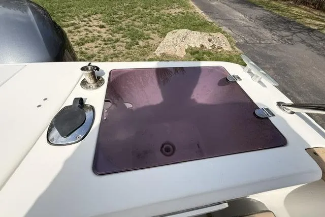 Slide: The Image of 2018 Jeanneau NC Sport 695 boat deck with hatch and winch, parked on grass. - 28