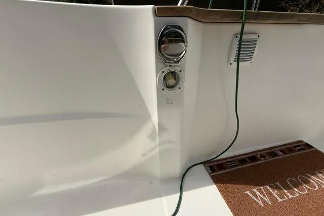 Slide: The Image of 2018 Jeanneau NC Sport 695 boat deck with welcome mat and hose connection. - 29