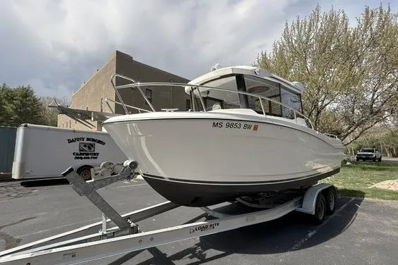 Slide: The Image of 2018 Jeanneau NC Sport 695 boat on trailer in parking lot. - 3